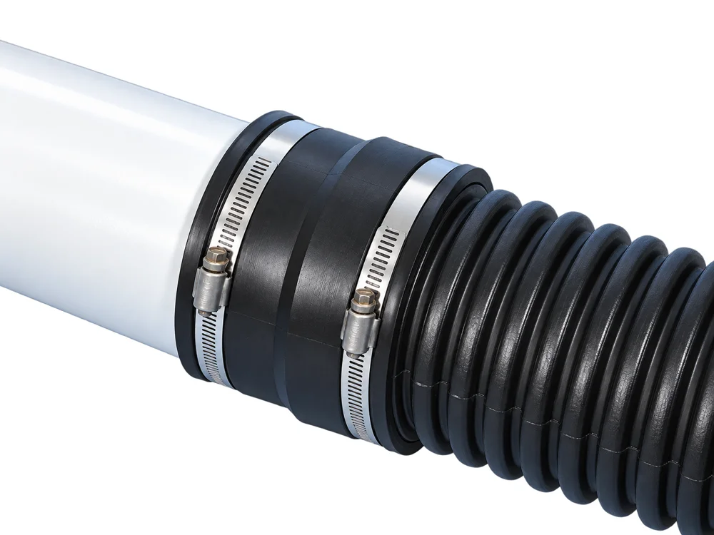 Fernco 1070 coupling joining corrugated polyethylene pipe to white PVC pipe